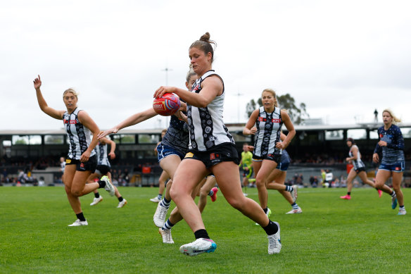 Collingwood’s Brianna Davey kicks her team forward against Geelong.