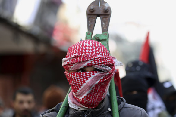 A masked member of Hamas at a protest against the Mid East plan announced by US President Donald Trump, in Gaza City, last month. 
