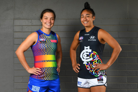 Ellie Blackburn and Darcy Vescio show off their teams' pride jumpers for this weekend.