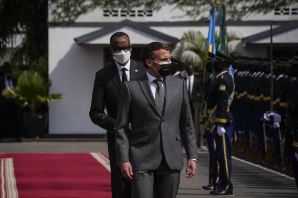 French President Emmanuel Macron  and Rwandan President Paul Kagame inspect a guard of honour  in Kigali on Thursday.