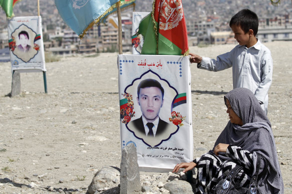 An Afghan woman sits by her son's gravee on the outskirts of Kabul as the peace talks began last year. 