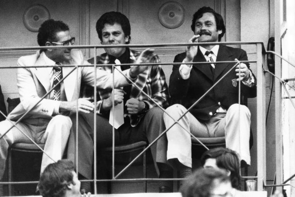 Barassi (right) enjoys the closing stages of North Melbourne’s 1975 VFL grand final win over Hawthorn with Bill Stephen (left) and Max Ritchie.