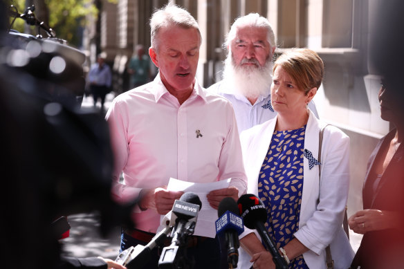 Andrew Prestney and his wife, Belinda Prestney, parents of Josh Prestney, and Stuart Shulze, the husband of Lynette Taylor, speak outside court.