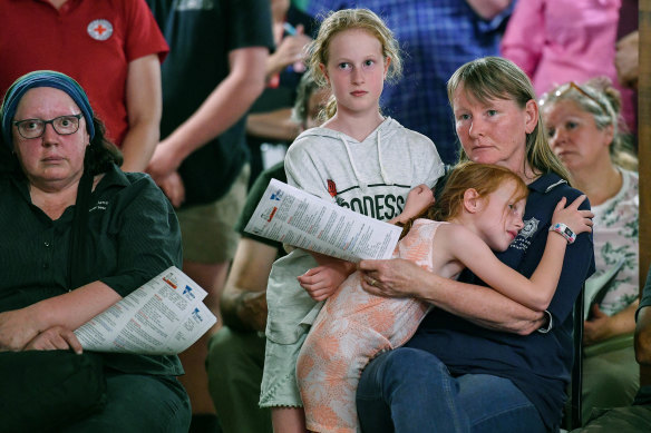 Emma West, aged 10, and her sister Aimee, seven, with their aunt Gretel West at the Clifton Creek community meeting.