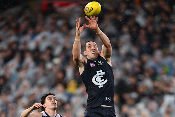 Jacob Weitering of the Blues takes the ball.