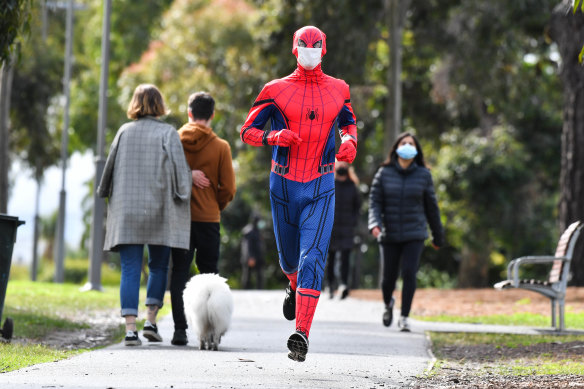 Socially distanced and double-masked ... jogger Stuart Tyson, as Spider-Man, has brought joy to Melburnians in lockdown.
