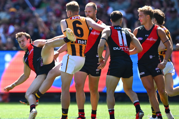 James Sicily of the Hawks gives away a free kick to Andrew McGrath of the Bombers.