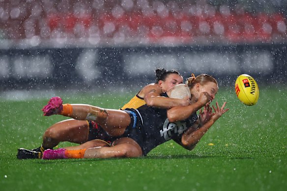 Sophie McKay, Tamara Smith and their Blues and Hawks teammates played in at-times monsoonal conditions on Thursday night.