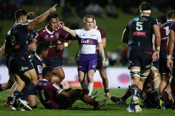 Damon Murphy signals advantage in a game between the Reds and the Rebels.