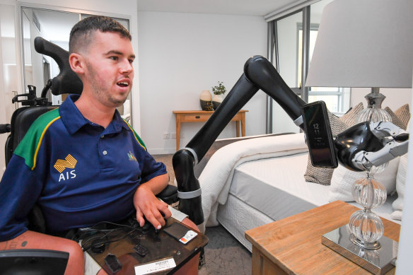 Dan Michel uses a robotic arm at home.