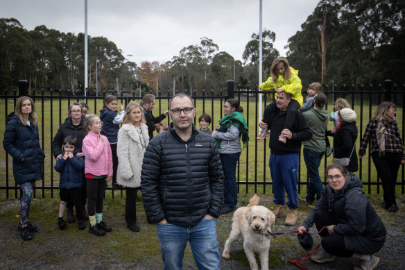 Parent Luke Geddes (centre) and members of Upwey Primary School’s community at the oval.