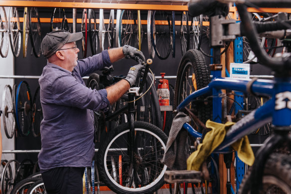 Volunteer Jonathan Wicker, at Revolve Recycling, helps fix bikes that are to be given away to disadvantaged children.