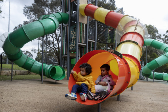 Dastagir and Maaz Mohammed  play on a tube slide at Strathfield Park.