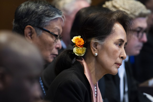 Myanmar's leader Aung San Suu Kyi and Gambia's Justice Minister Aboubacarr Tambadou, left, listen to judges in the court room.