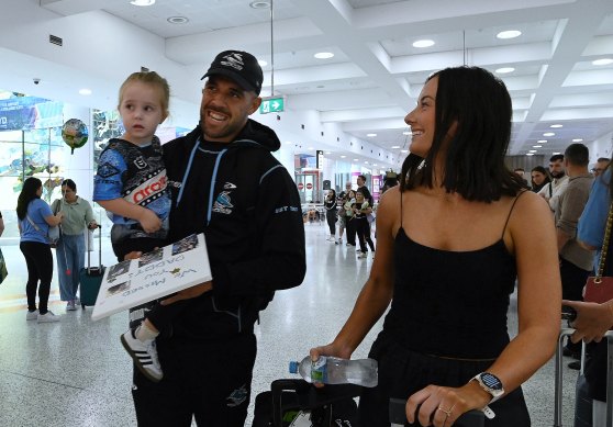 Will Kennedy (centre) is greeted by his 2yr old daughter Rose and partner Grace McDonald.