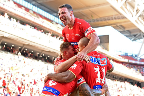The Dolphins celebrate a try in their win over the Roosters on Sunday.