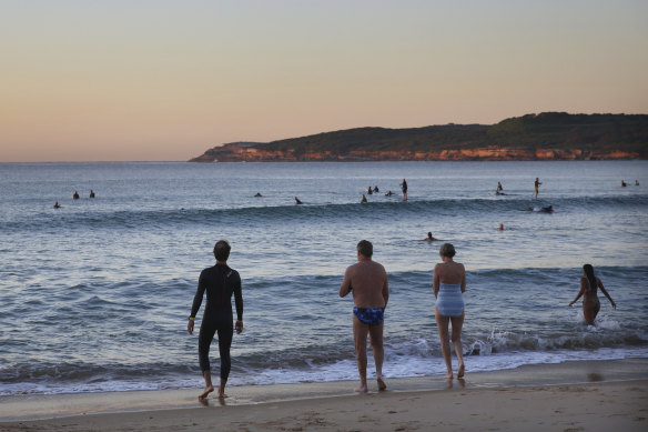 Bathers at Maroubra at dawn on Saturday before the beach was closed.