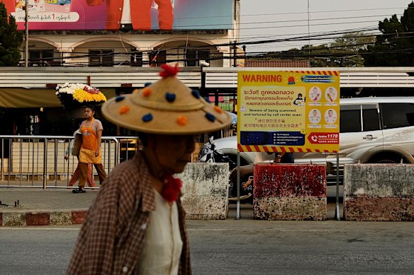 A sign warning people about scam centres and human trafficking at an immigration checkpoint on the Thai side of the border.
