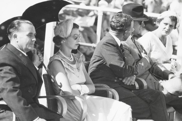 Queen Elizabeth and the Duke of Edinburgh (second from right) watch the surf carnival staged for them at Bo<em></em>ndi Beach on February 6, 1954.