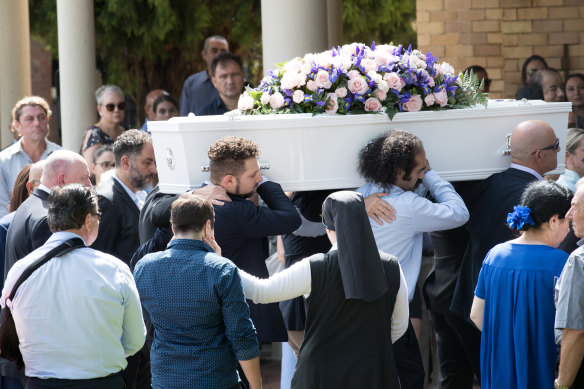 Pallbearers carry Veronique Sakr's coffin into the service.