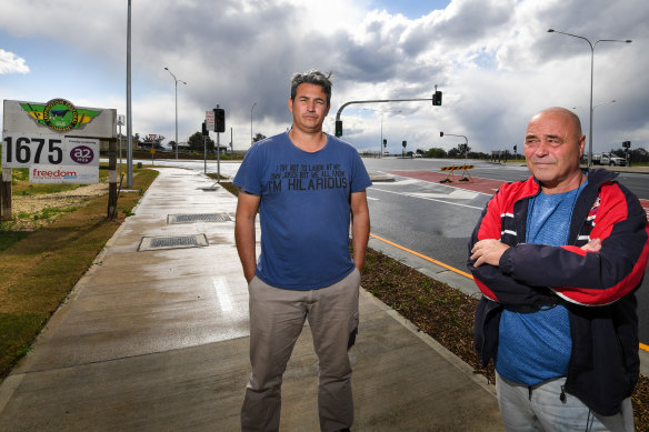 Small landowners Paul Coyto and Peter Srzich at the new traffic lights in front of the Leppington Pastoral Company's  main entrance.