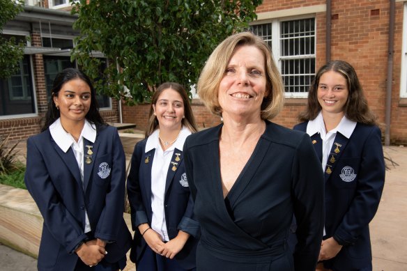 High school teacher Sandra Moore has been well since being treated with a breakthrough melanoma treatment three years ago. With her are Burwood Girls High School students (l-r) Arisha Sahay, Lili Franco and Alyssa Broughton.
