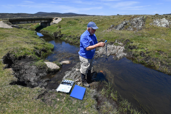 Professor Geoffrey Hope of the Australian National University examines the pH of the water near Yarrangobilly in Kosciuszko National Park. 