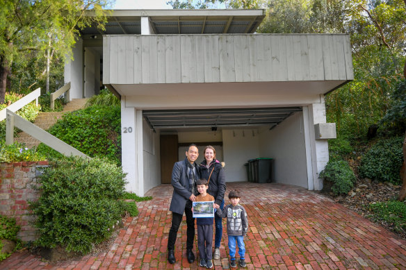 Craig Tan with wife Gemma and their children after their success at the auction.