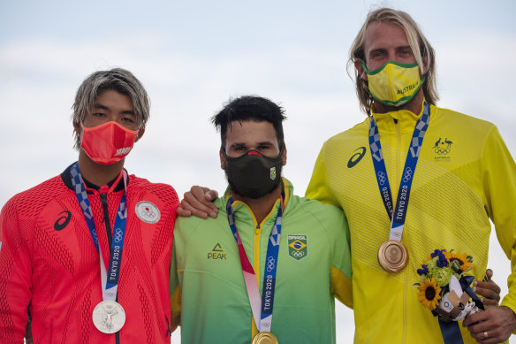 Brazil’s Italo Ferreira, center, holding the gold medal, Japan’s Kanoa Igarashi, left, silver medal, and Australia’s Owen Wright, bronze medal.