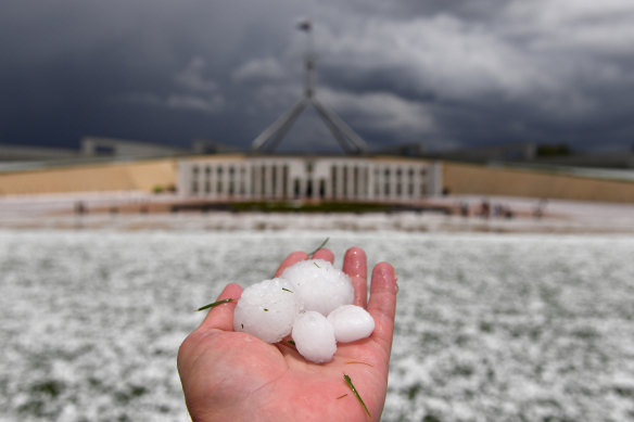 Golf ball-sized hail blankets the lawn in front of Parliament House, Canberra. 