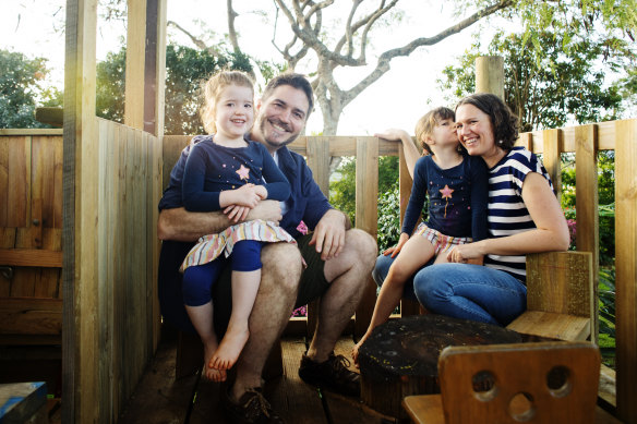 Cam Hollows at home with his wife Jane McKenzie-Hollows and his two daughters Matilda (5) and Tabitha (3.5) in the treehouse he built for them. Hollows' late father Fred was a famous eye doctor.