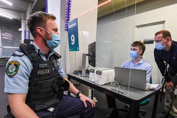 The first emergency service workers  line up to be vaccinated at the RPA Vaccination Centre in Mallett Street Camperdown on Monday.