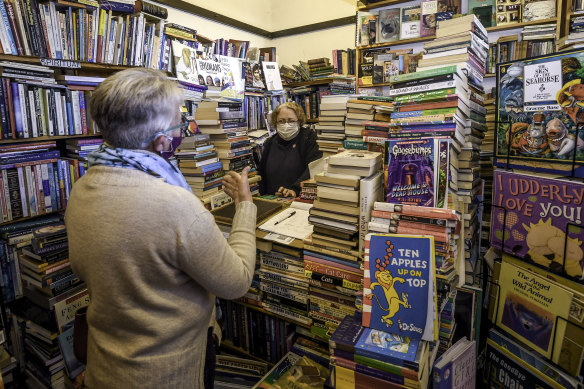 Soldier and Scholar bookshop owner Joyce Sanders serves a customer on the first morning after lockdown six. 