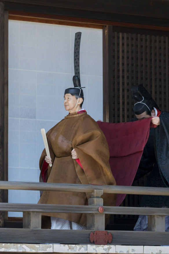 Naruhito takes a ritual walk to report the dates of his enthronement ceremony to the imperial ancestors at the Imperial Palace in Tokyo in May.