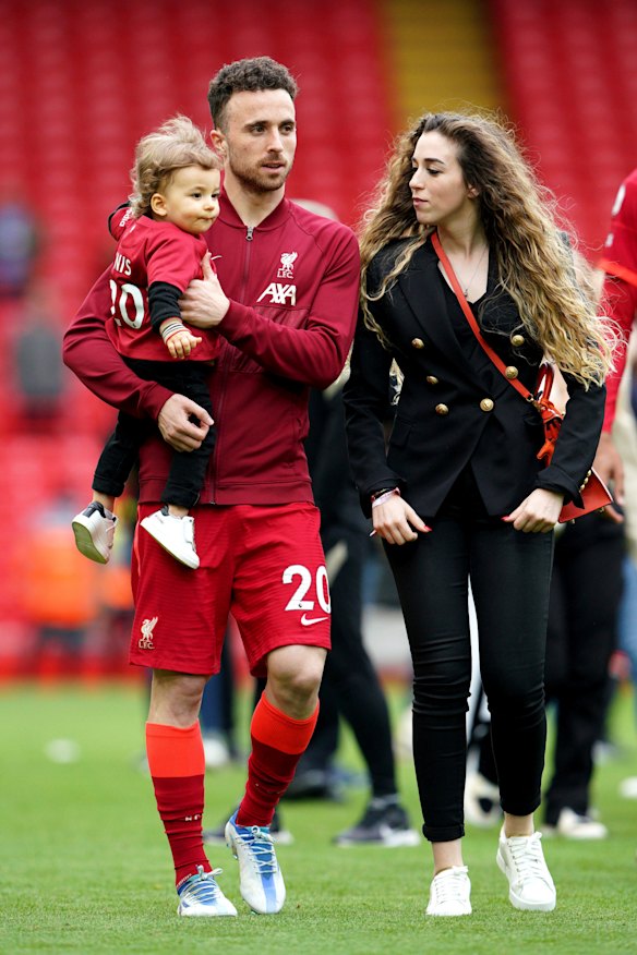 Liverpool’s Diogo Jota walks the pitch with his family after a Premier League match in 2022.