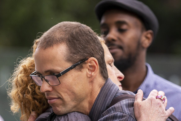 Family friend Brad Coath (left) is seen outside the Federal Court in Melbourne