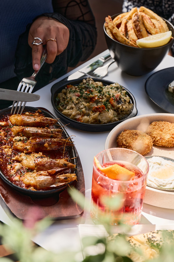 Snacks include prawn saganaki and eggplant dip.