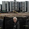 Long-time Kensington resident Simon Harvey stands near some of the Macaulay Road build-to-rent projects.