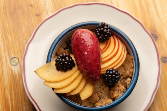 Fruit baked under a crunchy topping, served with a scoop of deep purple berry sorbet.