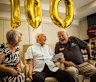 A world away from war: Max Caldwell, centre, at his 100th birthday party in Blackburn. At right is Michael Ralston, son of Gilbert Ralston, a 2/14 Battalion member, with Ralston’s wife Elaine at left.