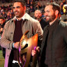 Greg Inglis and Dallas Johnson carry out a replica of the 2009 premiership trophy that the NRL stripped from the Storm.