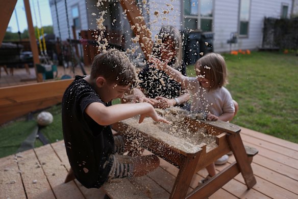 Eileen Lamb, centre, who was diagnosed with autism as an adult, works with her son Charlie Lamb, left, who also has autism, and daughter Billie at their home in Austin