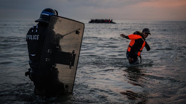 French police enter the water at Gravelines to try to stop migrants boarding small boats in June.