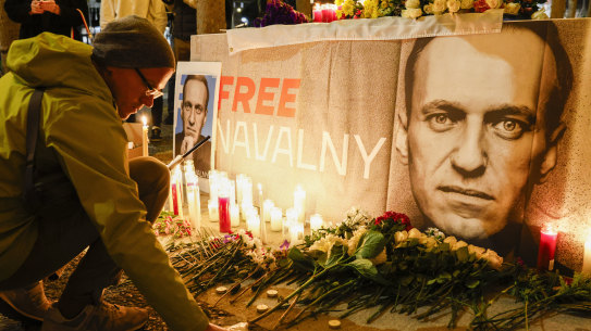 Pavel Shumilkin lights candles for a vigil held for Alexei Navalny outside City Hall in San Francisco on Friday night.
