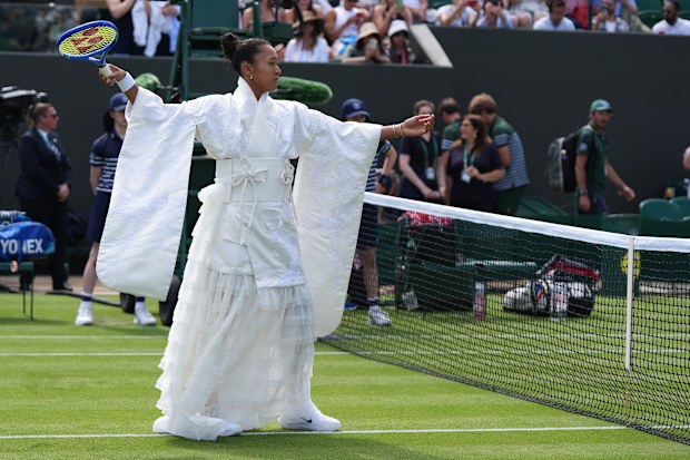 Naomi Osaka walks into the court to play against Elsa Jacquemot in their first round women's singles match at the Wimbledon Tennis Championships in London, Monday, June 29, 2026.