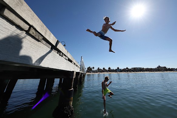 Harry, 10, and Artie, 8, jump off the pier at Kerferd Road, St Kilda.