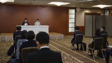 Low key: Mako and her husband Kei Komuro address the press on Tuesday.