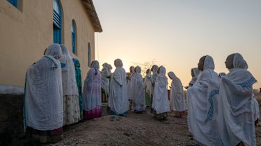 Orthodox Christian Tigrayan refugees who fled the conflict pray in front of a church at Hamdeyat Transition Centre in Sudan near the Ethiopian border.