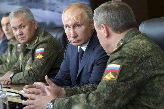 Russian President Vladimir Putin and Russian Defence Minister Sergei Shoigu, left.