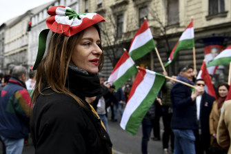 A woman look on as thousands of supporters of Hungary’s right-wing populist prime minister, Viktor Orban, gather in Budapest, Hungary.